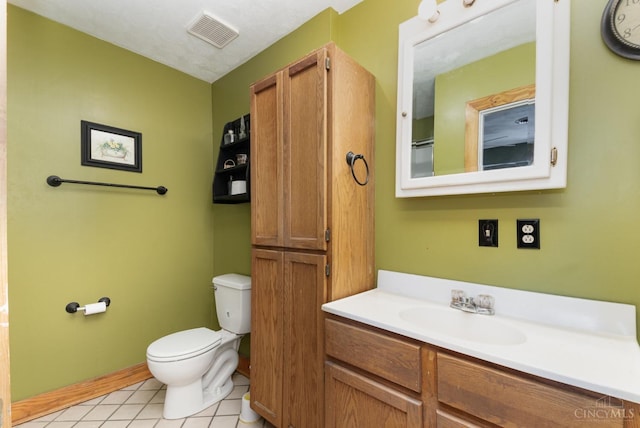 bathroom with toilet, tile patterned floors, vanity, and visible vents