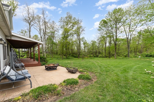 view of yard with an outdoor fire pit and a patio
