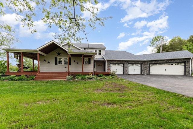 view of front of property with a porch, driveway, a garage, a front yard, and a shingled roof