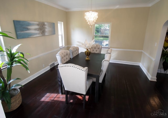 1103 Towanda Ter, Cincinnati, OH 45216 - dining space featuring a notable chandelier, baseboards, visible vents, hardwood / wood-style flooring, and arched walkways