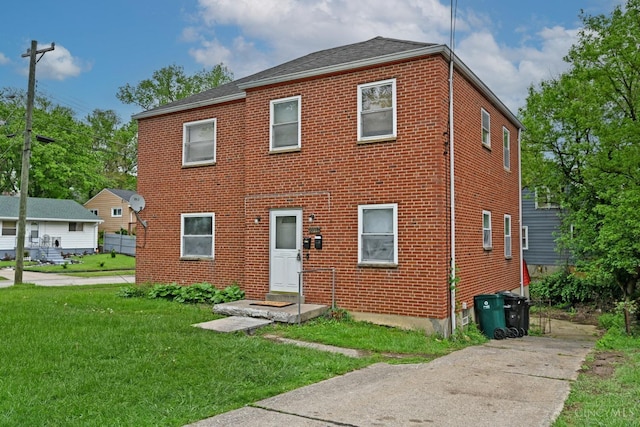 6014 Argus Rd, Cincinnati, OH 45224 - view of front facade with a front yard and brick siding
