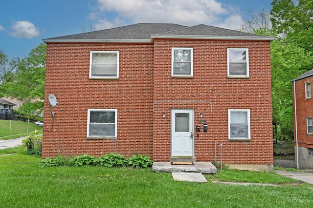 6014 Argus Rd, Cincinnati, OH 45224 - back of property with brick siding, a lawn, and roof with shingles