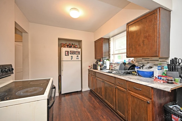 6014 Argus Rd, Cincinnati, OH 45224 - kitchen featuring white appliances, dark wood-style flooring, light stone counters, backsplash, and brown cabinets