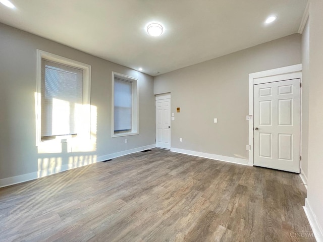 2259 Loth St, Cincinnati, OH 45219 - empty room with wood finished floors, baseboards, and recessed lighting
