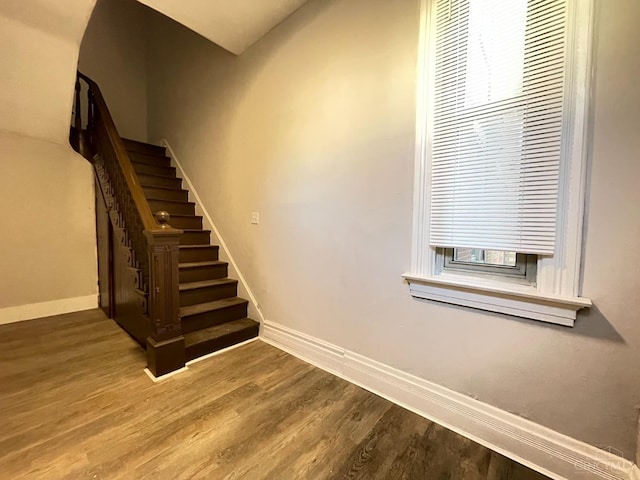 2259 Loth St, Cincinnati, OH 45219 - stairs featuring baseboards, wood finished floors, and plenty of natural light