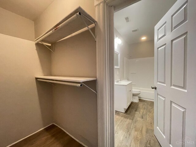 2259 Loth St, Cincinnati, OH 45219 - spacious closet with wood finished floors and a sink