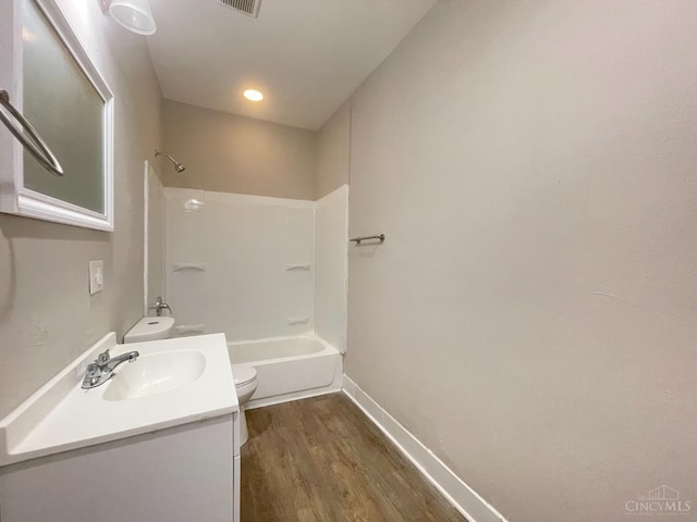 2259 Loth St, Cincinnati, OH 45219 - full bath with toilet, vanity, wood finished floors, baseboards, and shower / bath combination