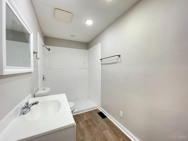 2259 Loth St, Cincinnati, OH 45219 - full bath with toilet, a shower, wood finished floors, and vanity