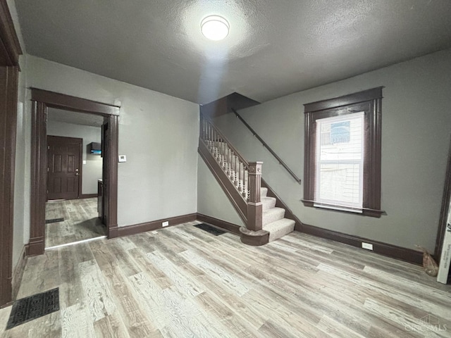1239 Sliker Ave, Cincinnati, OH 45205 - interior space featuring light wood-type flooring, stairway, a textured ceiling, and baseboards