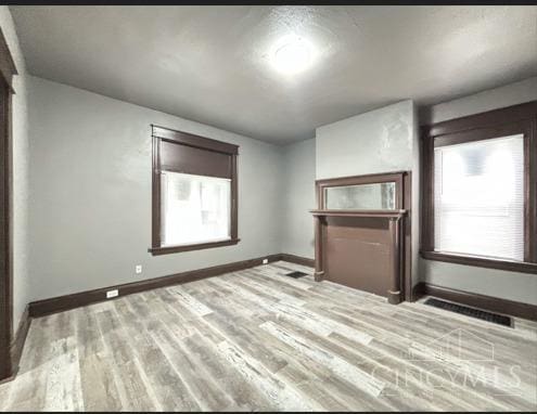 1239 Sliker Ave, Cincinnati, OH 45205 - unfurnished living room featuring baseboards and wood finished floors