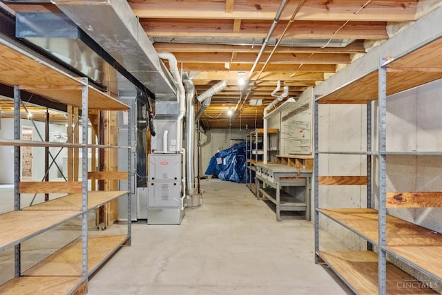 unfinished below grade area featuring heating unit