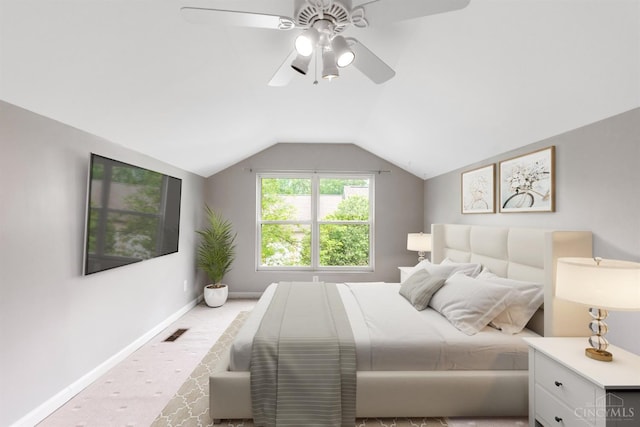 carpeted bedroom featuring vaulted ceiling, ceiling fan, and baseboards