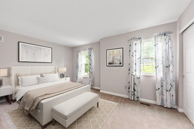 carpeted bedroom featuring baseboards
