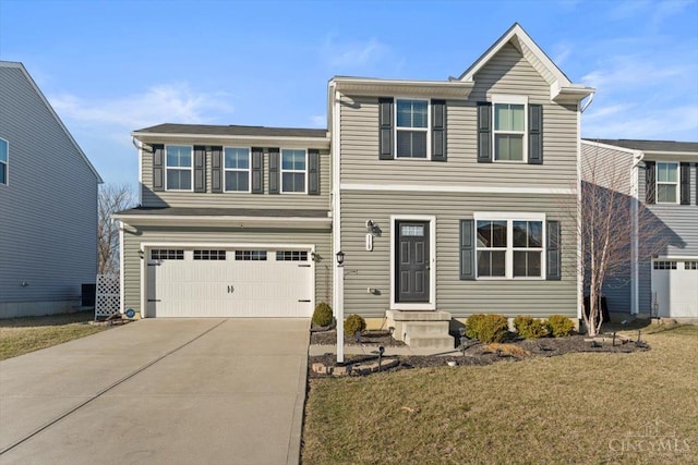 traditional-style home with a garage, concrete driveway, a front yard, and entry steps