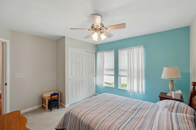 bedroom with carpet flooring, baseboards, a closet, and ceiling fan
