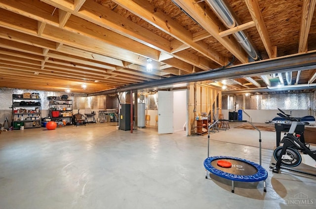 unfinished below grade area featuring gas water heater and heating unit