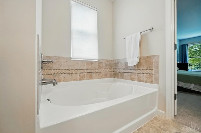 ensuite bathroom featuring a garden tub