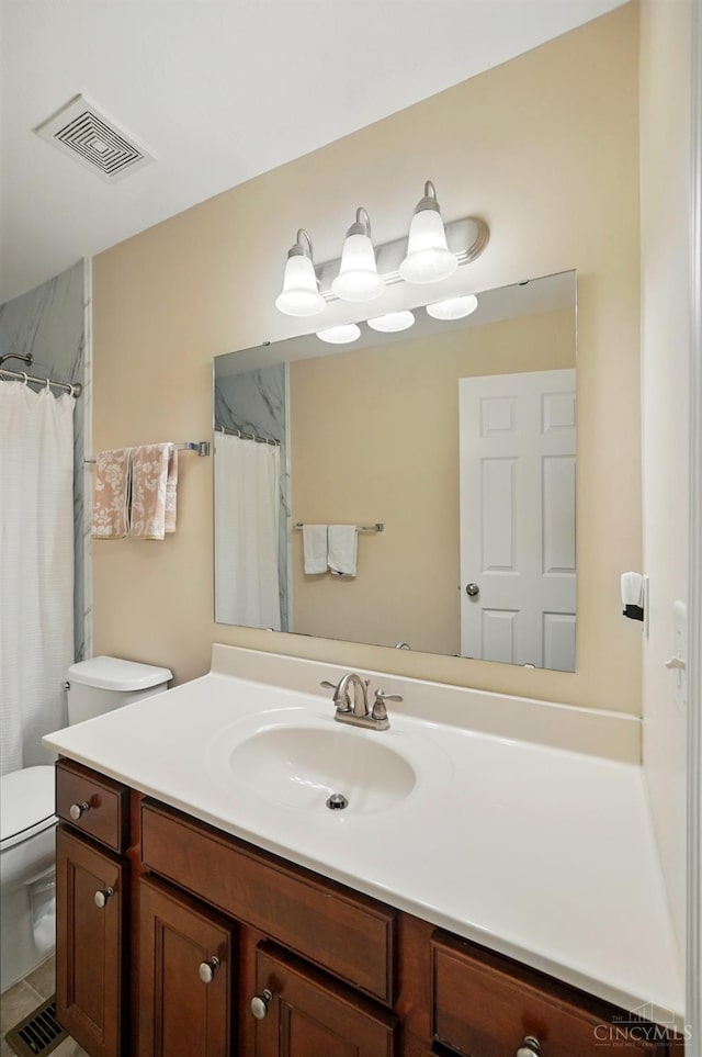 full bath featuring vanity and toilet