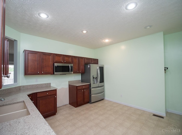 9413 Stoneybrooke, Springfield Twp, OH 45231 - kitchen featuring appliances with stainless steel finishes, a sink, recessed lighting, and a textured ceiling