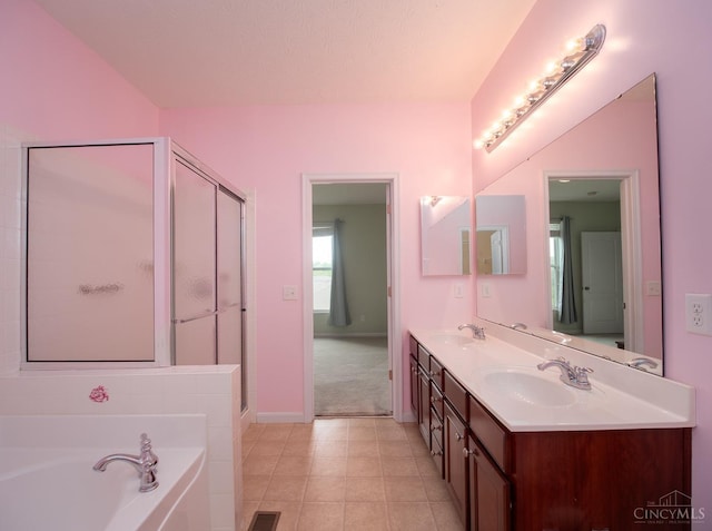 9413 Stoneybrooke, Springfield Twp, OH 45231 - bathroom with a bath, double vanity, a shower stall, baseboards, and tile patterned floors