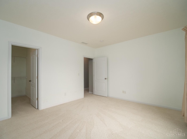 9413 Stoneybrooke, Springfield Twp, OH 45231 - unfurnished bedroom with light colored carpet, a walk in closet, baseboards, and a closet