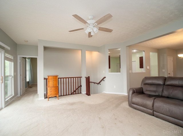 9413 Stoneybrooke, Springfield Twp, OH 45231 - living area with light colored carpet, ceiling fan, baseboards, and a textured ceiling