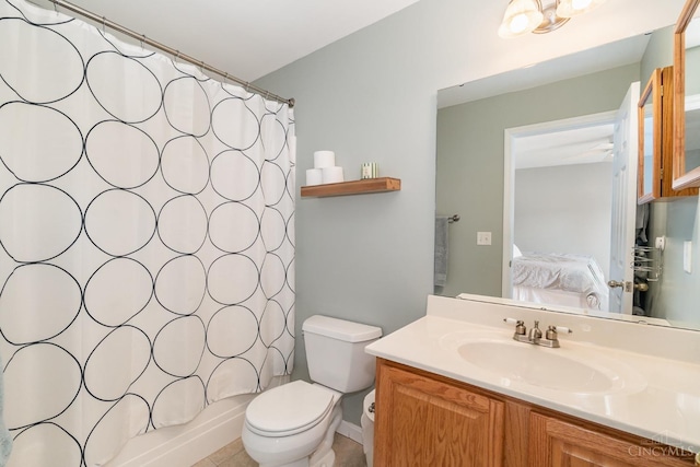 ensuite bathroom featuring toilet, vanity, and shower / tub combo