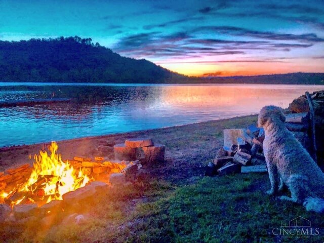 water view featuring an outdoor fire pit and mountains