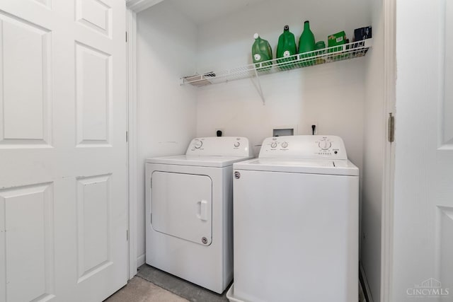 clothes washing area featuring washer and clothes dryer