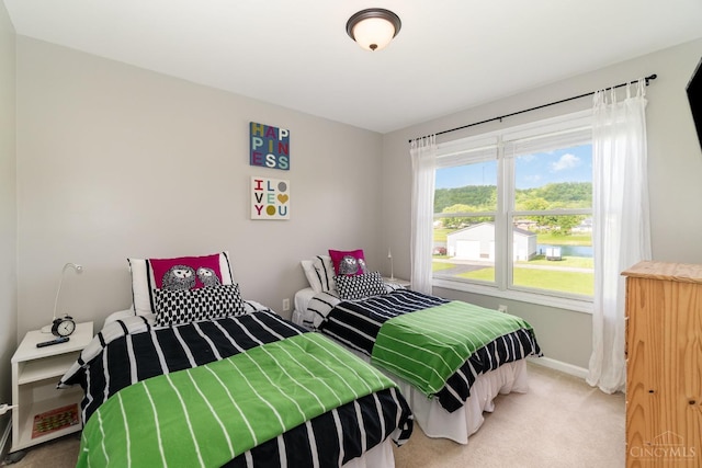 bedroom featuring carpet floors and baseboards