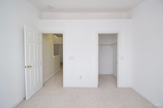6720 Kelseys Oak Ct, Green Twp, OH 45248 - unfurnished bedroom with carpet, baseboards, a spacious closet, and a closet