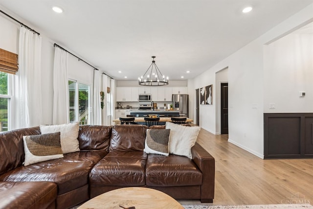 1750 Parkfield Way, Goshen Twp, OH 45122 - living area featuring healthy amount of natural light, light wood-style floors, a chandelier, recessed lighting, and baseboards