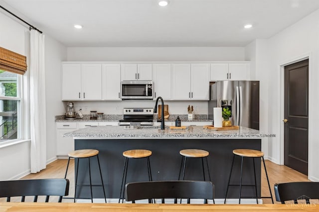 1750 Parkfield Way, Goshen Twp, OH 45122 - kitchen with appliances with stainless steel finishes, a sink, light wood-style floors, white cabinets, and recessed lighting