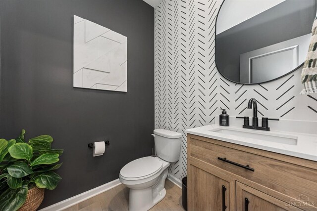 1750 Parkfield Way, Goshen Twp, OH 45122 - half bath featuring toilet, baseboards, wood finished floors, and vanity
