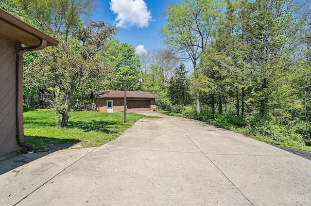 11675 New Biddinger Rd, Harrison Twp, OH 45030 - view of property exterior featuring a yard, a garage, and brick siding