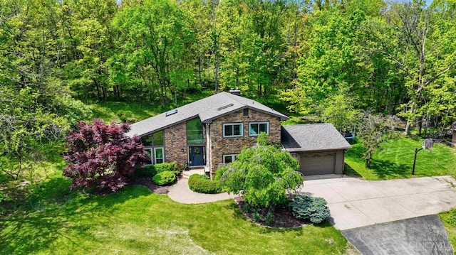 11675 New Biddinger Rd, Harrison Twp, OH 45030 - view of front of property with driveway, stone siding, an attached garage, and a front yard
