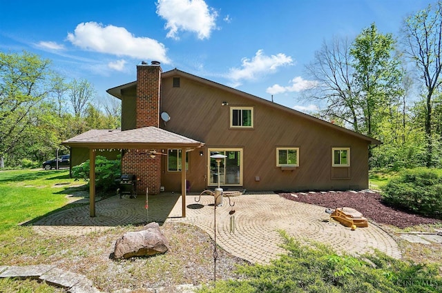 11675 New Biddinger Rd, Harrison Twp, OH 45030 - rear view of house featuring a patio area, a chimney, and a yard