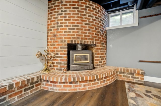 11675 New Biddinger Rd, Harrison Twp, OH 45030 - detailed view of wood finished floors, a wood stove, and baseboards