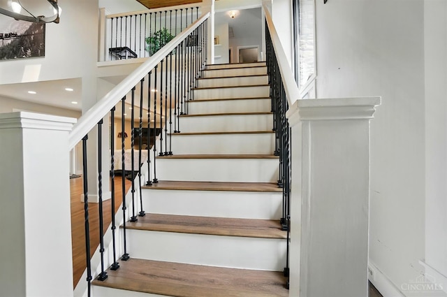 11675 New Biddinger Rd, Harrison Twp, OH 45030 - stairway with wood finished floors and a towering ceiling
