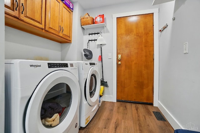 11675 New Biddinger Rd, Harrison Twp, OH 45030 - laundry area with cabinet space, wood finished floors, independent washer and dryer, and baseboards