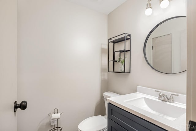 bathroom featuring toilet and vanity