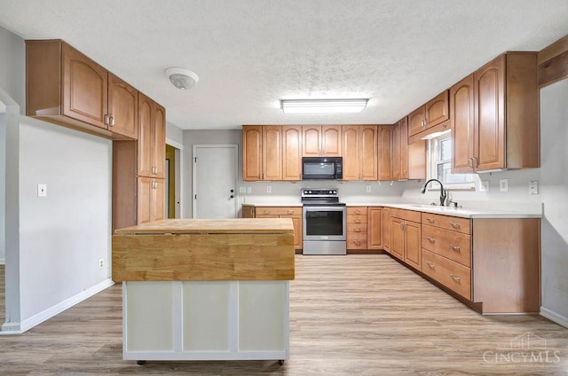 2774 N Law Rd, Reily Twp, OH 45056 - kitchen featuring electric stove, black microwave, light wood-style flooring, a sink, and a textured ceiling