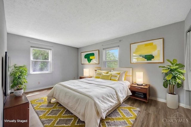 2774 N Law Rd, Reily Twp, OH 45056 - bedroom with wood finished floors, baseboards, and a textured ceiling