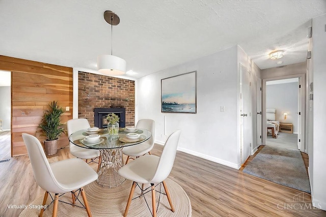 2774 N Law Rd, Reily Twp, OH 45056 - dining room featuring baseboards, light wood-type flooring, and a fireplace