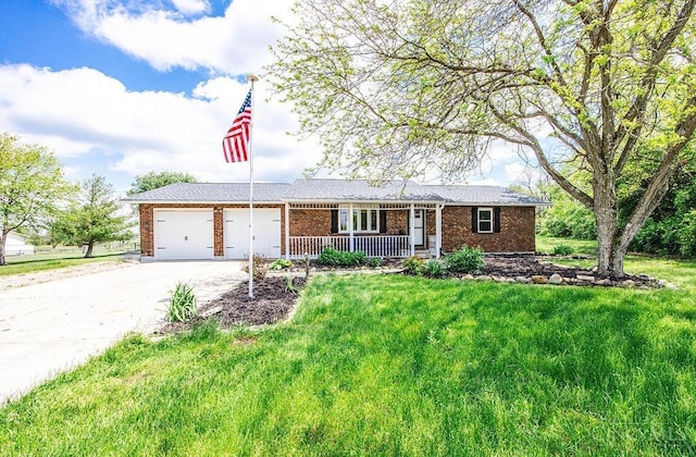 2774 N Law Rd, Reily Twp, OH 45056 - single story home with covered porch, brick siding, an attached garage, and driveway