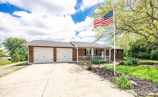2774 N Law Rd, Reily Twp, OH 45056 - view of front of property with covered porch, an attached garage, driveway, and brick siding