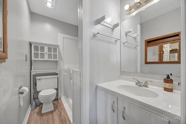 2774 N Law Rd, Reily Twp, OH 45056 - full bath with wood finished floors, toilet, and vanity