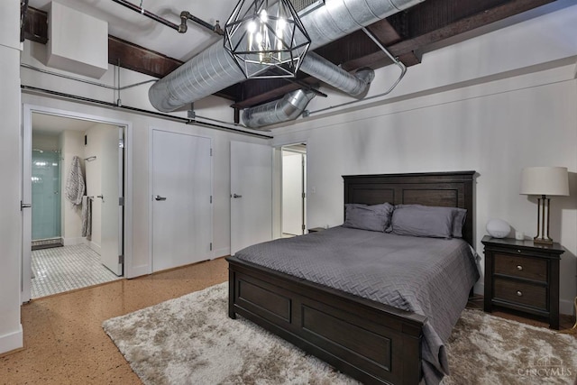 bedroom featuring speckled floor, baseboards, and ensuite bath