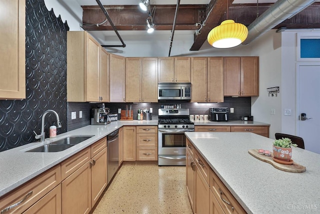 kitchen featuring stainless steel appliances, a sink, light brown cabinetry, and backsplash