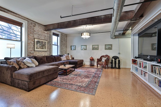 living area featuring speckled floor and baseboards